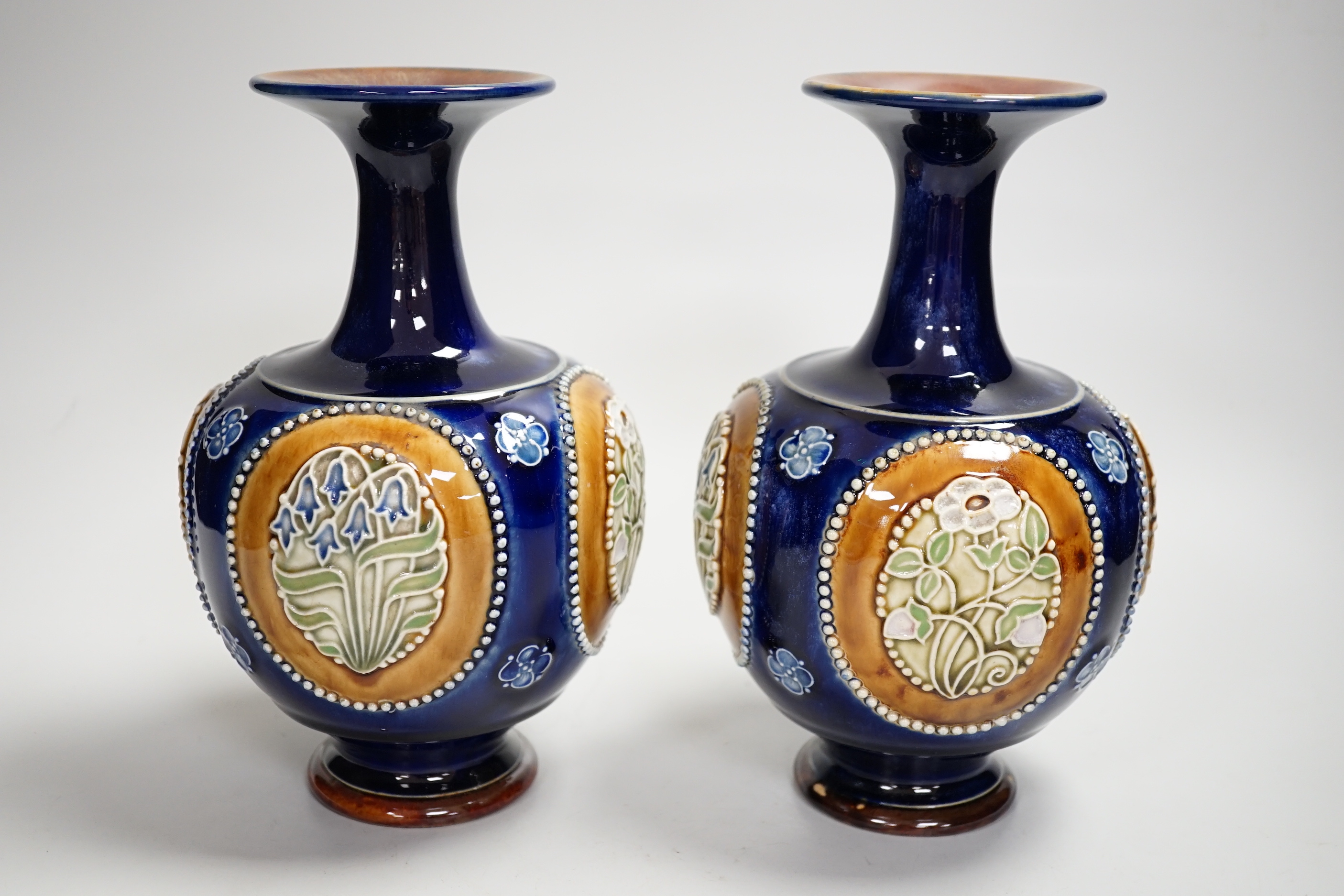 A pair of Royal Doulton vases, 22cm high
